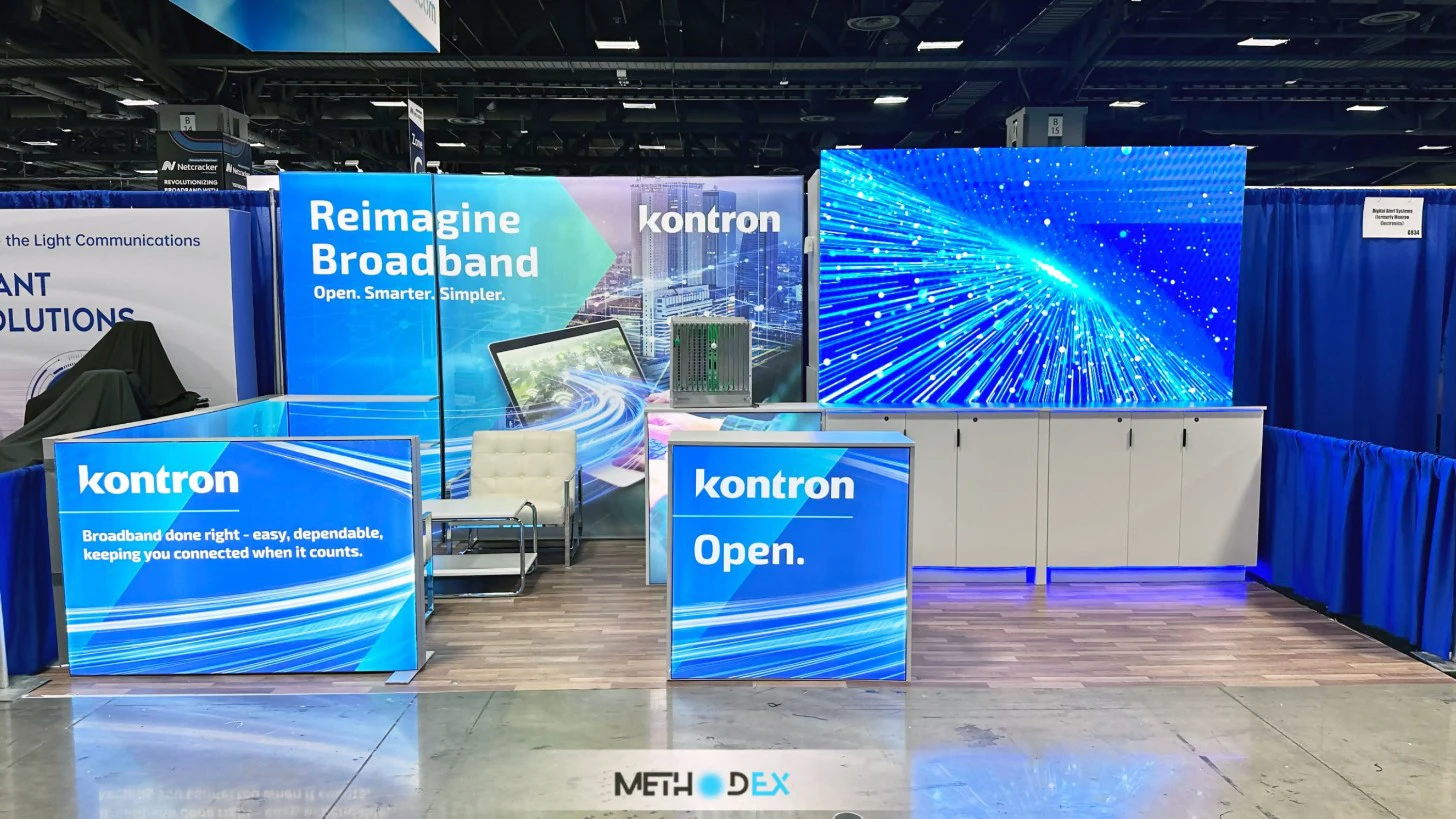 Kontron booth with blue backlit graphics, two backlit counters, an LED wall, white cabinets, and a lounge chair