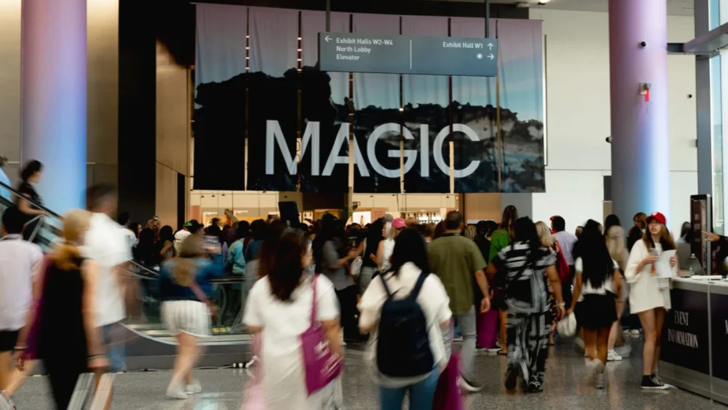Crowd in a Las Vegas Convention Center lobby under a large MAGIC banner and a directional sign for Exhibit Halls W1 to W4